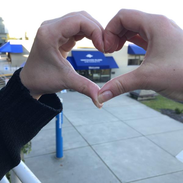 Fingers making a heart over the VIU logo