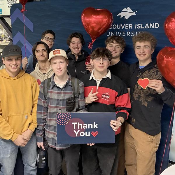 group of students holding heart cookies and a thank you sign