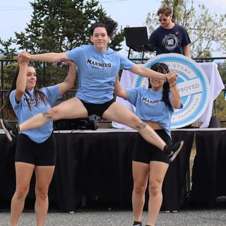 Cheerleaders in blue shirts.