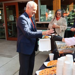 Dr. Michael Quinn receiving food at a National Truth and Reconciliation.