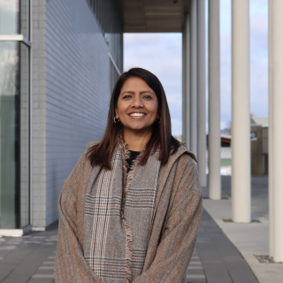 VIU Nursing professor Dr. Caroline Variath standing outside on a sunny day and smiling at the camera