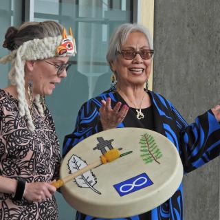 Aunalee Boyd-Good drums while Reanna Erasmus sings