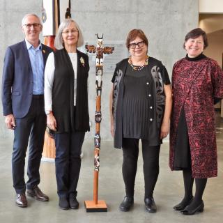 VIU and UVic Presidents and Chancellors pose with the Talking Stick