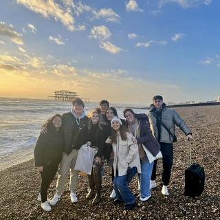 group photo of students on a beach