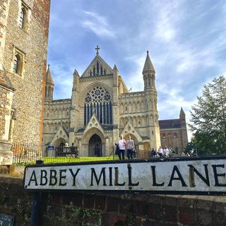 students in the background, a sign reads Abbey Mill Lane in the foreground