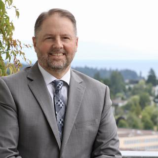 Dennis Johnson with a view of the Nanaimo campus and greenery behind him