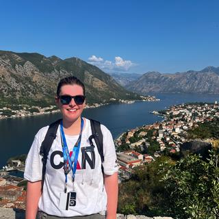 A woman with a beautiful vista view behind her