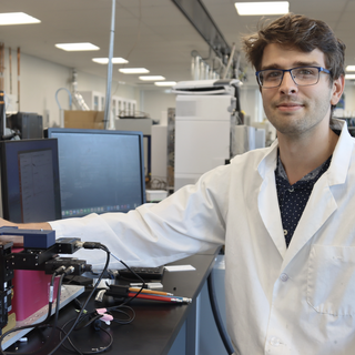 Joseph Monaghan in the lab showing the equipment