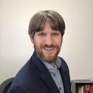 Daniel Westlake from the shoulders up with a white background