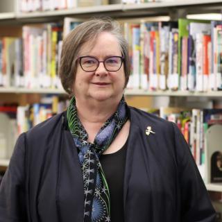 Marni in front of her comic collection