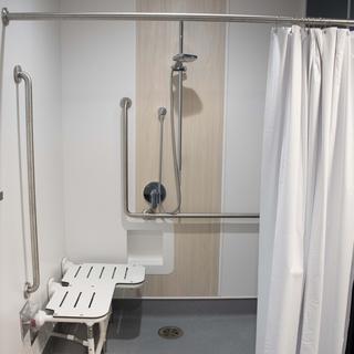 A shower stall with a seat.