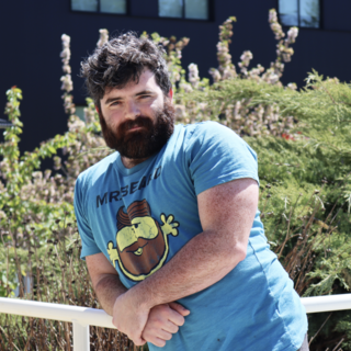 Philip Lawton leaning on railing and looking at the camera