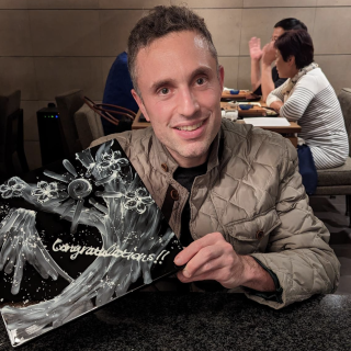 Avi Stenberg holding an award and smiling at the camera