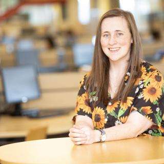 Sherry Wessel sits at a table in the library at VIU's Nanaimo campus