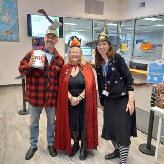 Three people in Halloween costumes 