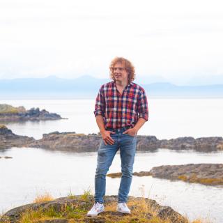 Ted with the ocean behind him