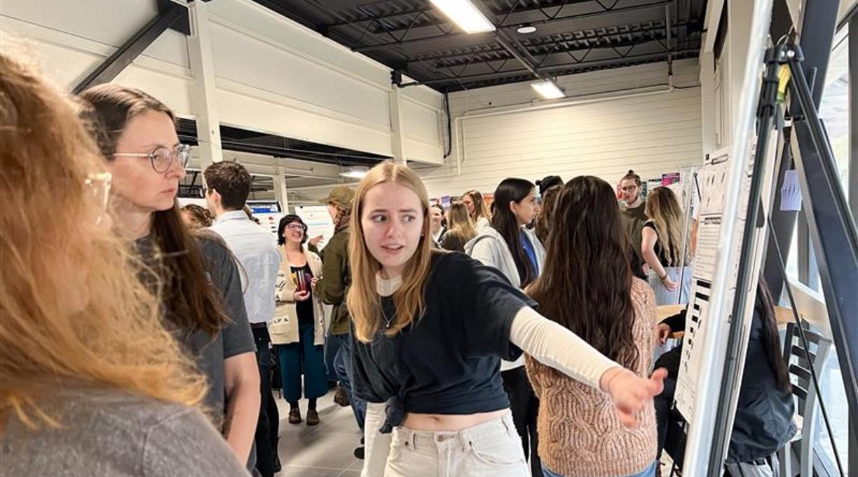 a student points at a poster board during the create conference