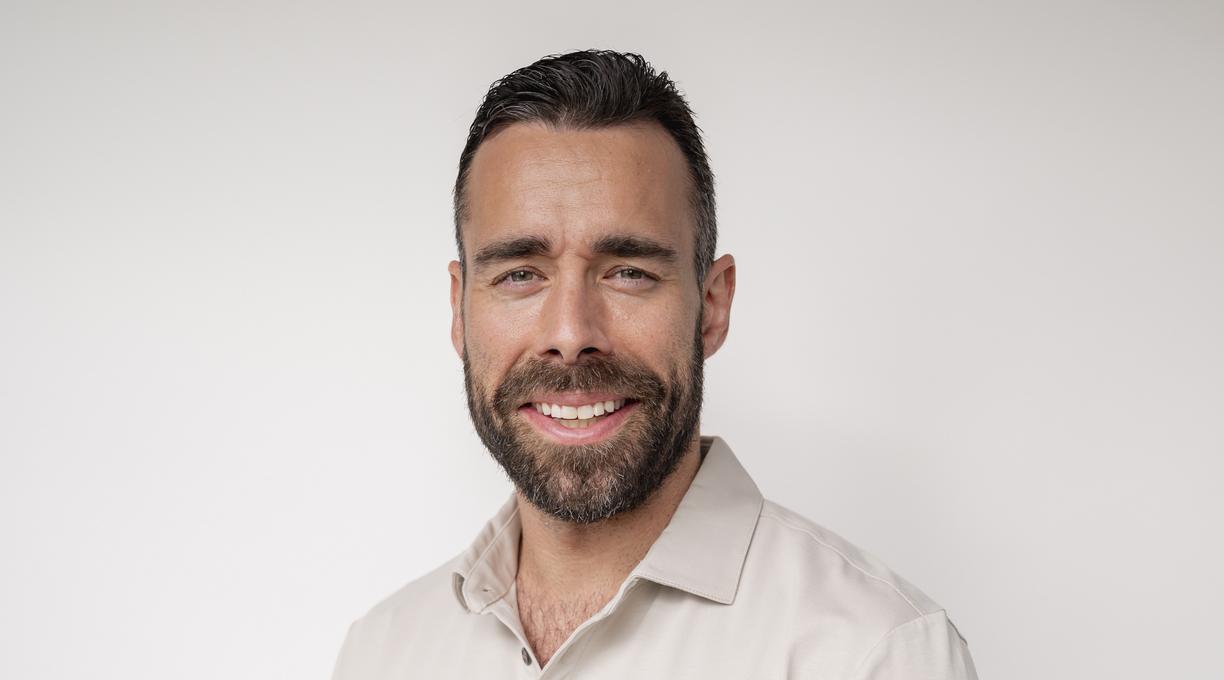 Jake torso and up portrait against a white wall
