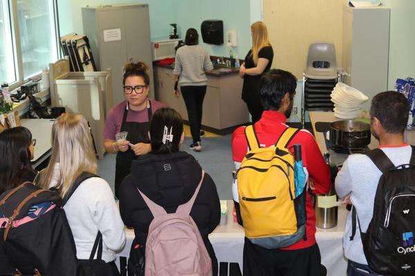 Leah serves food to students