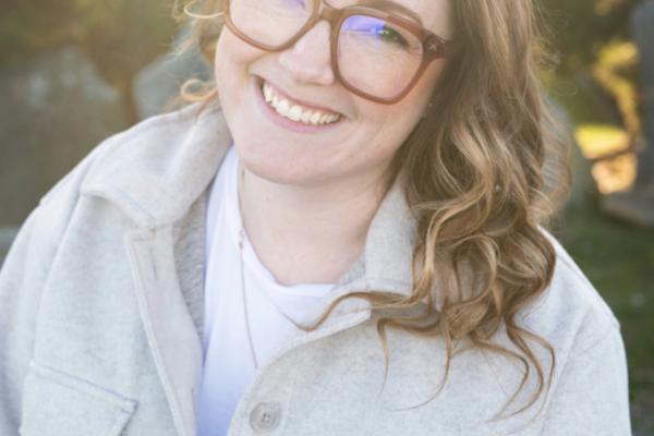 Ashley Kuramoto smiles with a natural and/or garden background