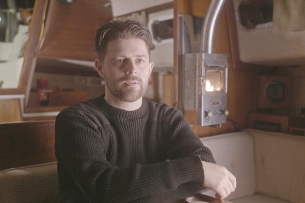 Bryce Casavant sits in the interior of a boat