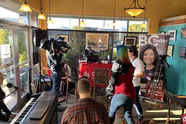 People doing a live broadcast in a coffee shop