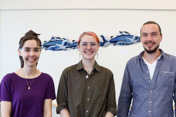 Simon Maguire, Lily Eggert and Trevor Michalchuk stand side-by-side smiling.