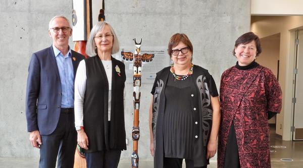 VIU and UVic Presidents and Chancellors pose with the Talking Stick