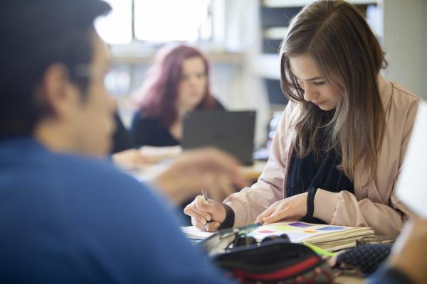 female student writing in notebook