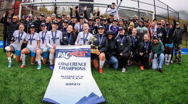VIU Mariners women's soccer team with championship banner