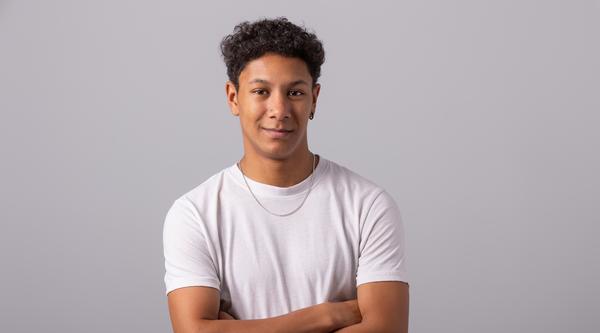 Michael Joseph standing with his arms crossed and smiling at the camera.