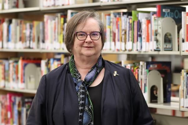 Marni in front of her comic collection