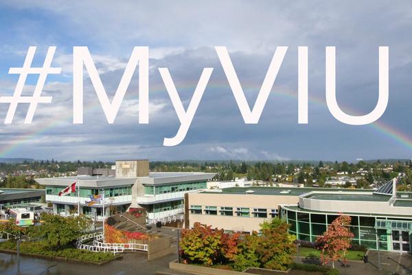 Picture of VIU's Nanaimo campus with a rainbow going across