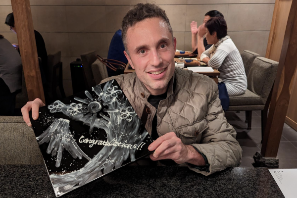 Avi Stenberg holding an award and smiling at the camera