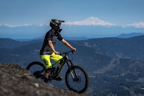 A mountain biker takes in the views on a sunny day