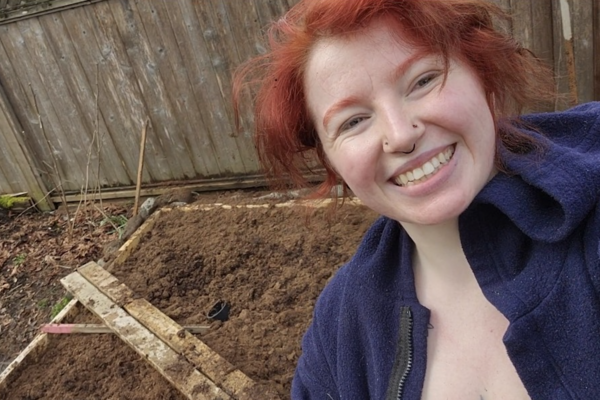 Halle Walle standing in front of her backyard bog and smiling at the camera