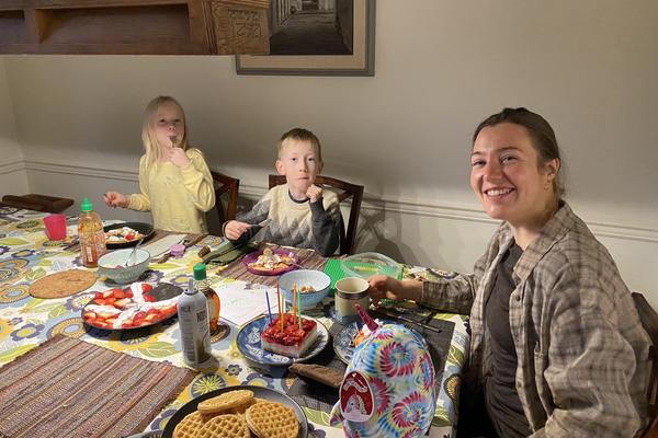 A breakfast table with two children and a female adult