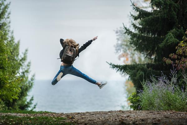 Student jumping in trees