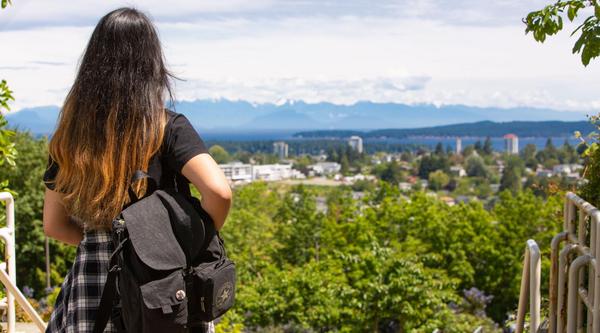 Student looks at the view wearing a backpack