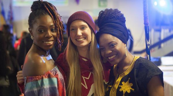 Three women smile at camera