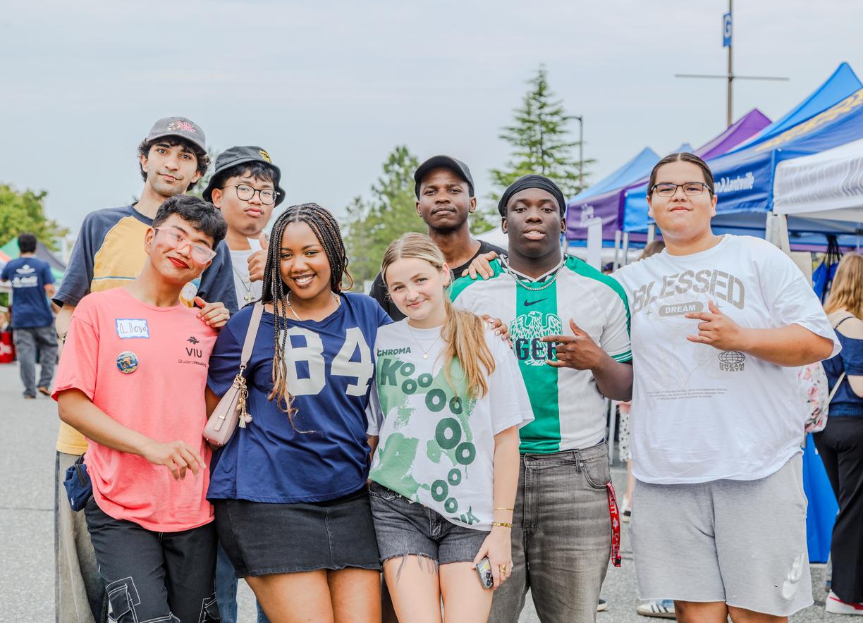 Group photo of students with tents in the background