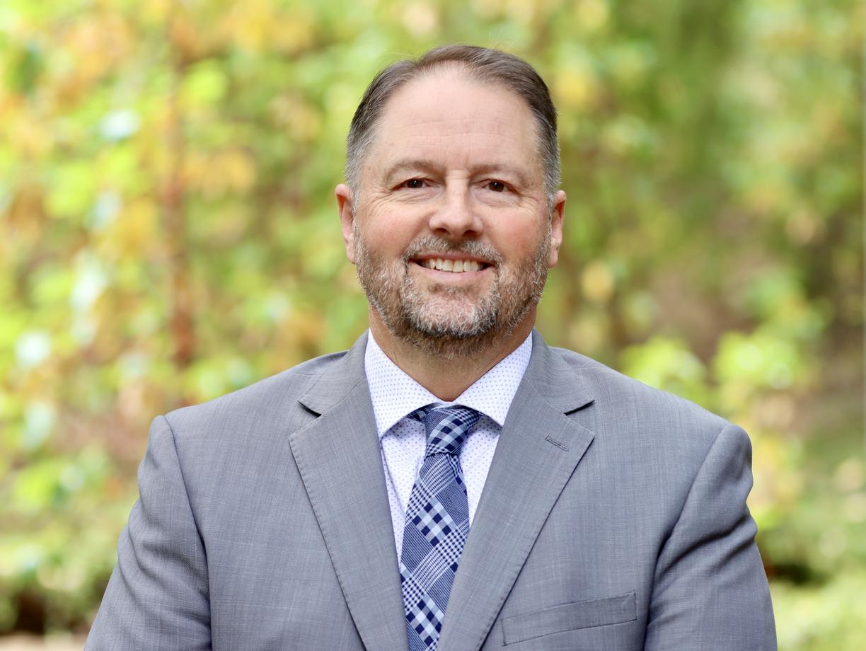 Dennis Johnson with a forest background