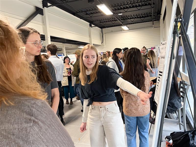 a student points at a poster board during the create conference