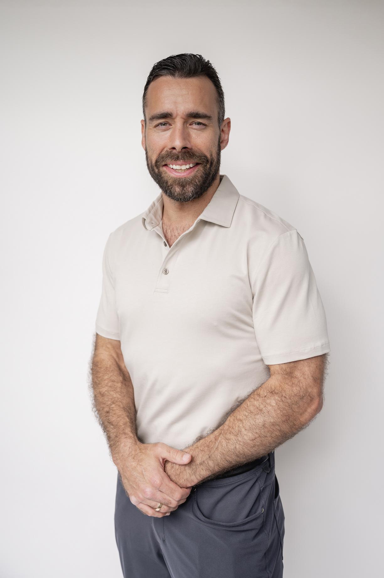 Jake torso and up portrait against a white wall