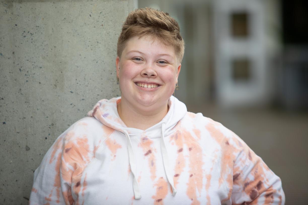 Tatum poses in front of a grey wall