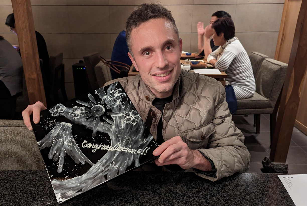 Avi Stenberg holding an award and smiling at the camera