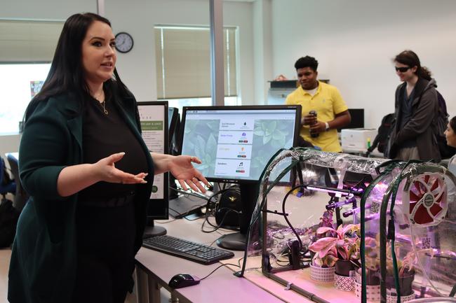 a student at the ITAS fair showing and talking abut their project