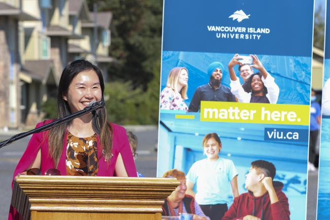 Former Advanced Education and Skills Training Minister Anne Kang speaks at a podium