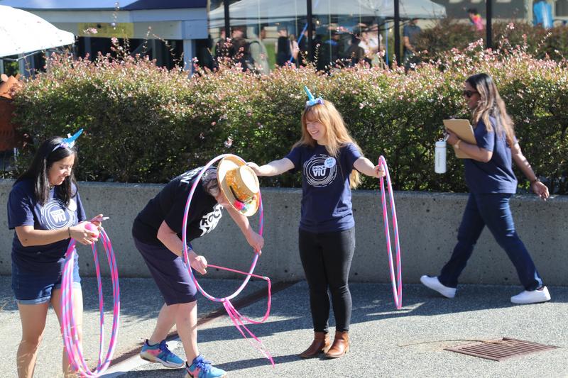 Students play with hula hoops outside the Malaspina Theatre