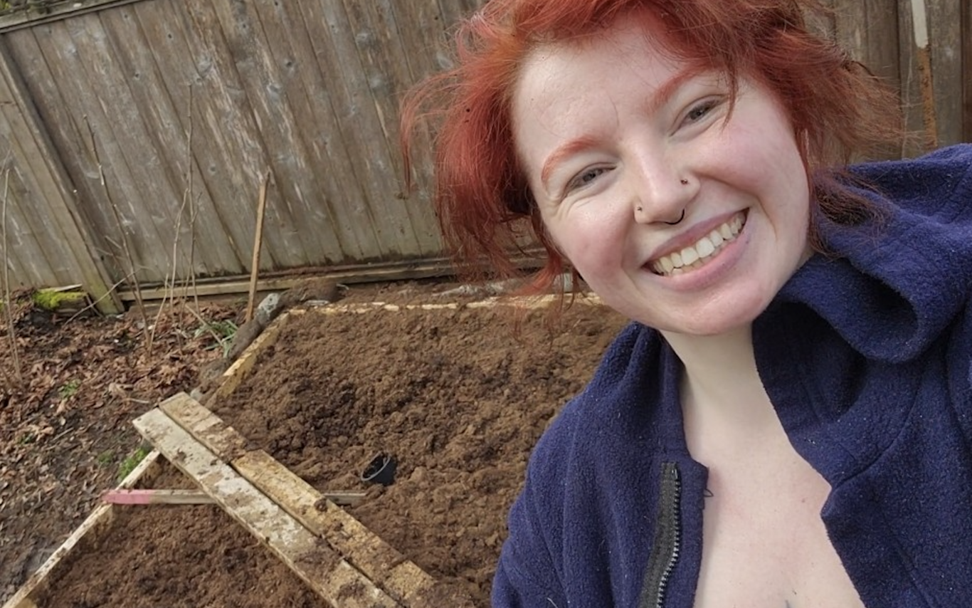 Halle Walle standing in front of her backyard bog and smiling at the camera